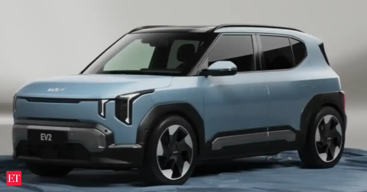 Front three-quarter view of the new Kia EV2, a compact electric SUV, parked in an urban environment.
