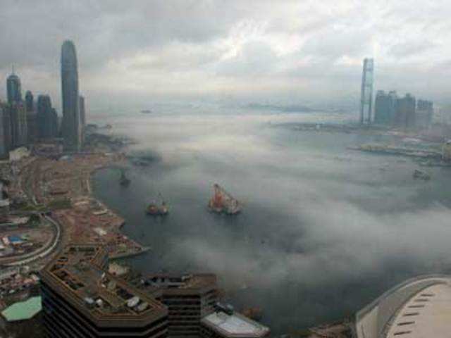 Morning fog rises off Victoria Harbor in Hong Kong