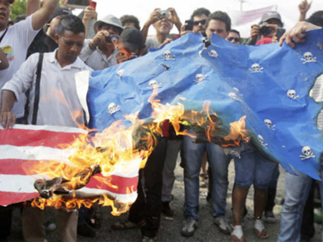 Protesters burn a mock US flag in Cartagena