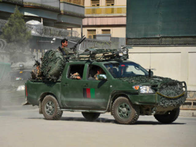 Afghan army soldiers drive toward the scene of attacks in Kabul