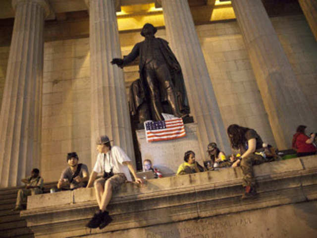 Occupy Wall Street protestors lounge on the steps of Federal Hall