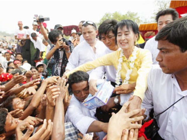 Myanmar leader Aung San Suu Kyi shakes hands with supporters 