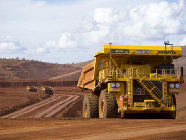 Remotely controlled tipper trucks operating at a Rio Tinto iron ore mine in Western Australia