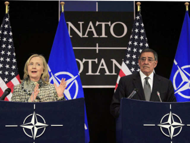 Hillary Clinton and Leon Panetta speaking at a conference 