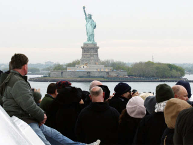 Passengers aboard the Titanic Memorial Cruise view the Statue of Liberty
