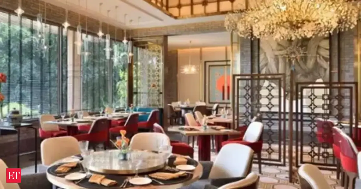 A bustling luxury hotel lobby in Delhi, indicative of high demand during a major AI summit and peak wedding season.