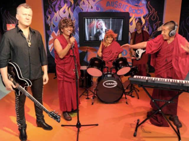 Gyuto Monks pose with wax figure of Jimmy Barnes