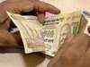 Rupee drops 15 paise against dollar on oil imports