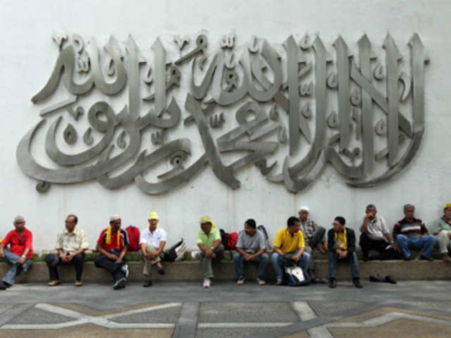 Protestors sit on the bench outside the National Mosque in Malaysia
