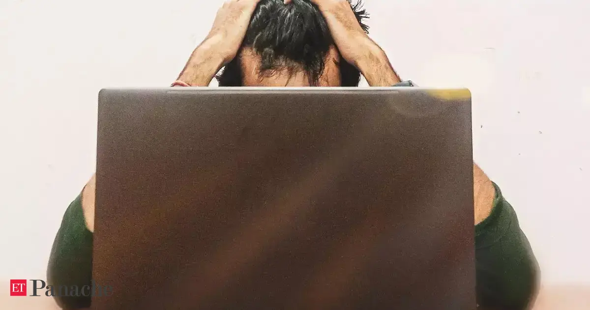 A determined man in front of a computer, surrounded by abstract AI and learning concepts, symbolizing reskilling.