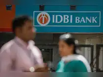 People walk past a branch of IDBI Bank in New Delhi