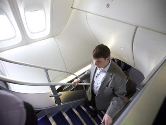 Visitor makes his way up stairs on a Boeing 747-8 Intercontinental