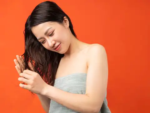 Why does she avoid daily hair washing