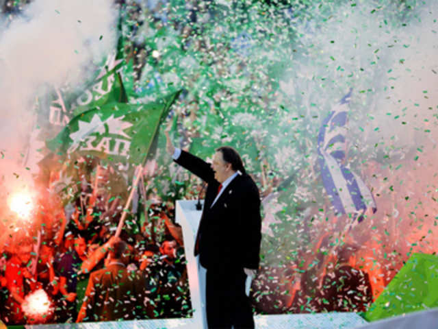 Evangelos Venizelos waves to supporters during a rally
