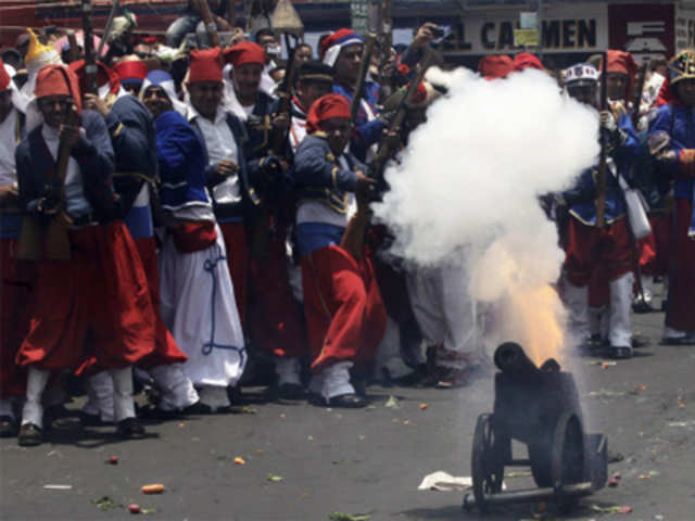 Mexicans fire a cannon during re-enactment of Puebla battle