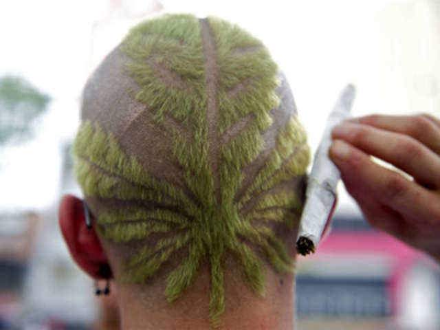 A man with haircut depicting cannabis plant during march