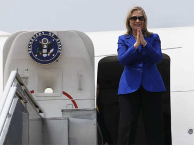 Clinton gestures before boarding her plane to Delhi