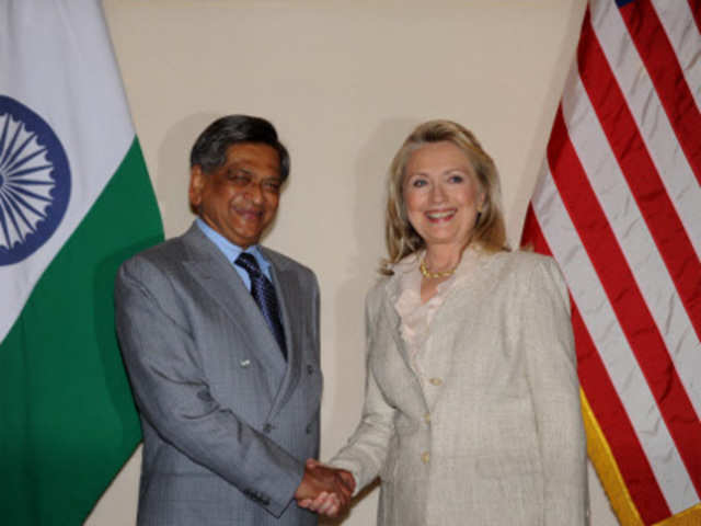Hillary Clinton shakes hands with S.M. Krishna before a news conference