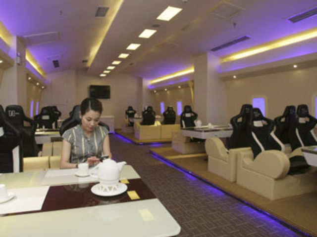An employee poses as a customer at an A380 theme restaurant