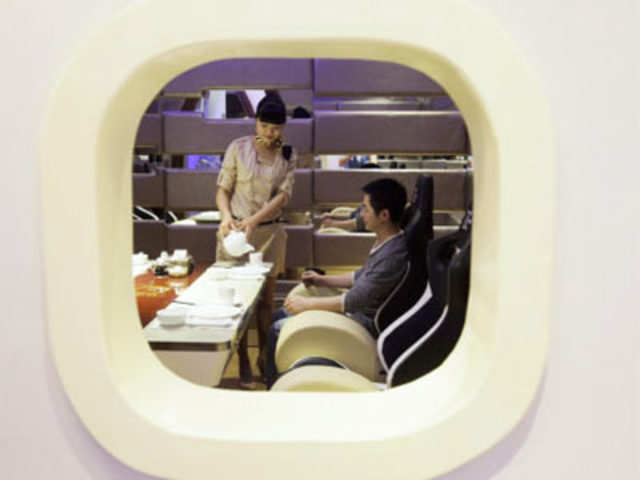 A waitress seen within a window, shaped to resemble a plane