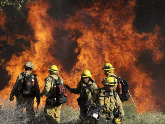 Los Angeles county firefighters battle a wall of fire
