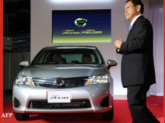 Toyota Motor president Akio Toyoda displays Corolla Axio sedan