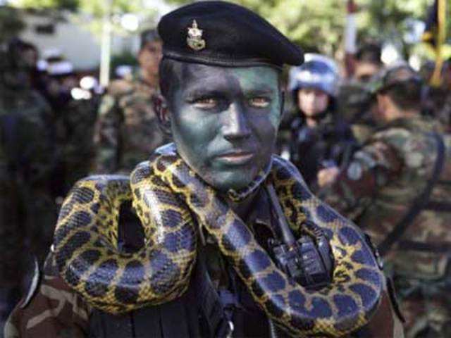 Officer Humberto Gimenez poses for a photo with a snake