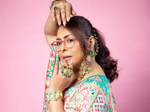 Rather than relying on heavy embellishments, the look uses bold jewellery, vibrant colours, and flowing fabrics to create a refined sense of glamour.
