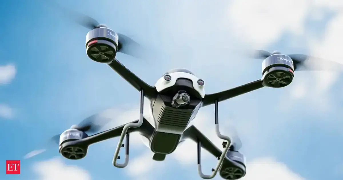 Multiple drones flying over an Indian city skyline, some carrying packages, symbolizing the growth in logistics and clean tech sectors.