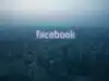Facebook reflected in a window before the Beijing skyline