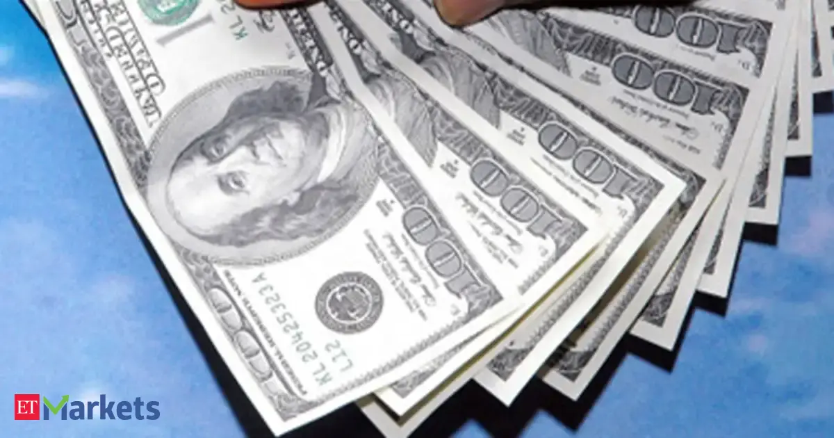 US dollar symbol rising above falling stock market graphs.