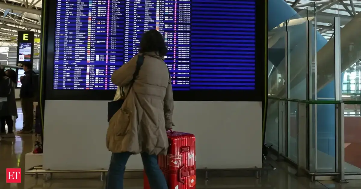 Japan cancels 100 flights as twin storms near 