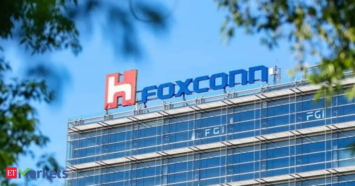 Foxconn logo displayed next to server racks, symbolizing growth from AI demand.