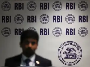 A man walks past the Reserve Bank of India (RBI) logo inside its headquarters in Mumbai