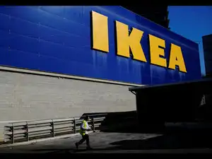 FILE PHOTO: Worker walks past a logo of IKEA on the facade of an IKEA store in Barcelona