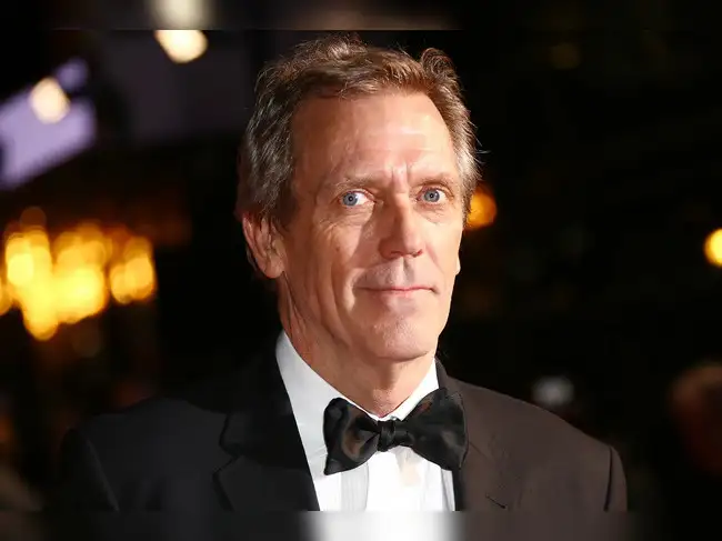 Quote of the day by Hugh Laurie highlights a famous line from Dr. Gregory House about dishonesty, human behavior, empathy, and understanding the reasons behind why people hide the truth. The quote reads: "It’s a basic truth of the human condition that everybody lies. The only variable is about what."