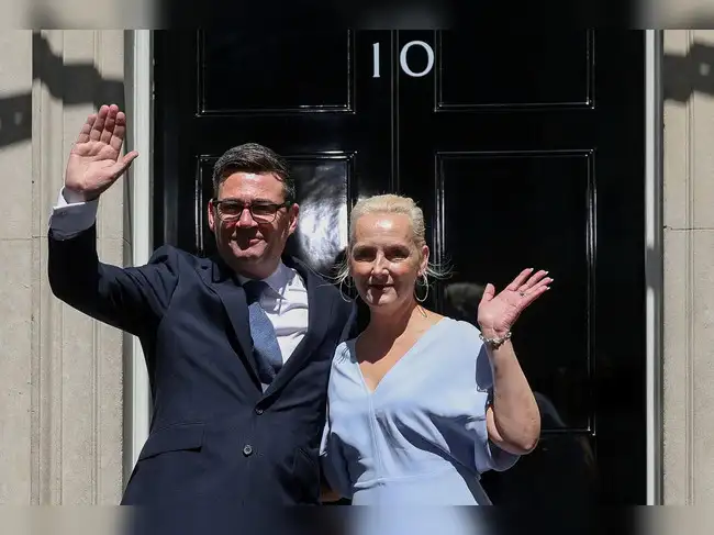 Andy Burnham waves outside 10 Downing Street with his wife Marie-France van Heel