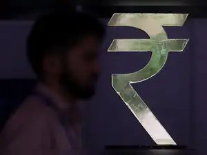 A man walks past a Rupee installation at the Reserve Bank Of India (RBI) headquarters in Mumbai