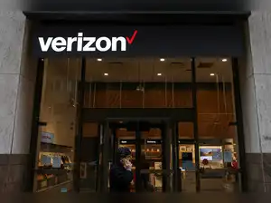 FILE PHOTO: A person walks by a Verizon store in Manhattan, New York City