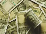 Competing cues, caution ahead of RBI policy decision keep rupee nearly flat