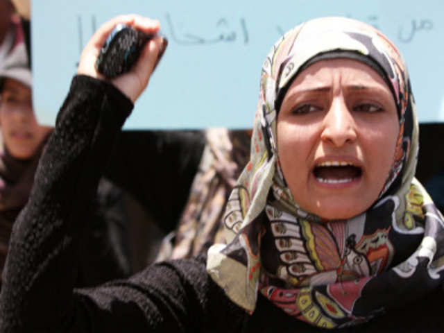 A rights activist shouts slogans outside the attorney general's office in Sanaa
