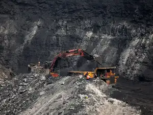 A loader loads coal in the truck at an open cast coal field at Topa coal mine in the Ramgarh district in the eastern Indian state of Jharkhand
