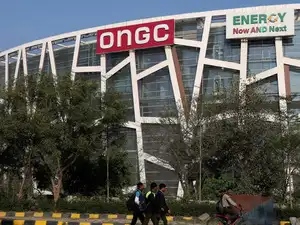 FILE PHOTO: People pass by in front of the Oil and Natural Gas Corporation Limited (ONGC) office in New Delhi
