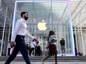 FILE PHOTO: People walk by the Apple store on Fifth Avenue in New York