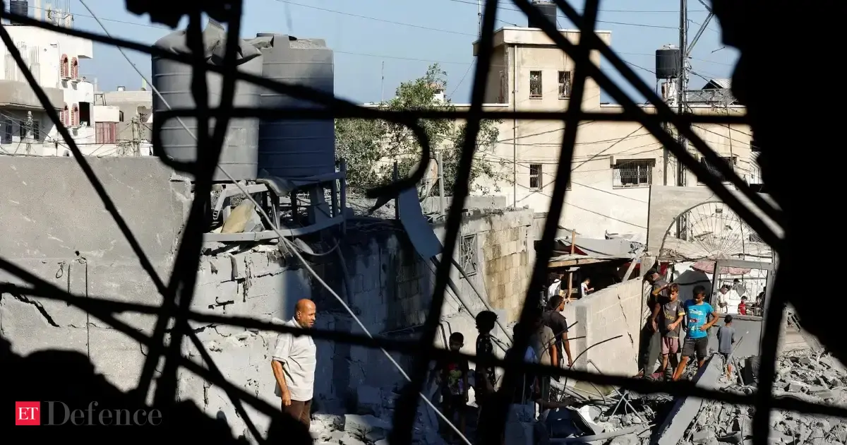 Palestinians inspect a mosque hit in an Israeli strike, in Deir al-Balah