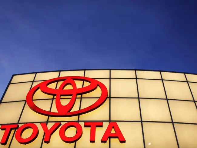 FILE PHOTO: The Toyota logo is lit up above Boch Toyota's dealership in Norwood
