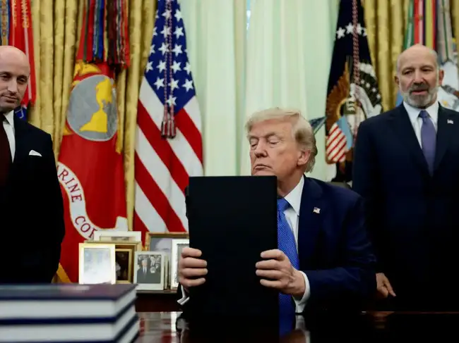 FILE PHOTO: U.S. President Donald Trump signs executive orders at the Oval Office in Washington