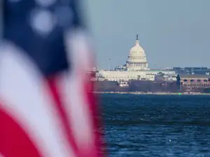 The U.S Capitol is seen in the background as a flag flies in Alexandria, Virginia