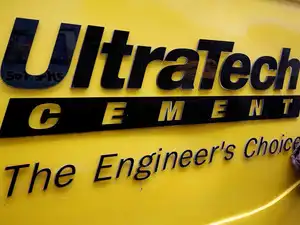 A man cleans an Expert Testing Van of UltraTech Cement outside a cement store in Ahmedabad