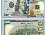 The blue ribbon on a $100 bill is not a printed decoration; the U.S. Currency Education Program says it is woven into the paper, and its bells and 100s move when tilted